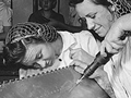 National Youth Administration trainees at the Corpus Christi, TX Naval Air Base, Evelyn and Lillian Buxkeurple are shown working on a practice bomb shell, 1942. (Image courtesy of the National Archives and Records Administration.)